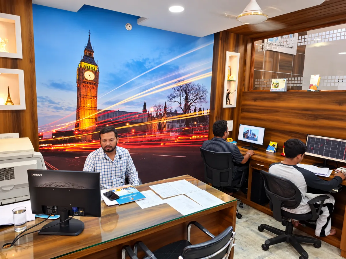 The team at work in the design workspace, under a wall mural of Big Ben